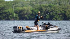 Woman standing on her Sea-Doo FishPro Trophy fullly equipped for